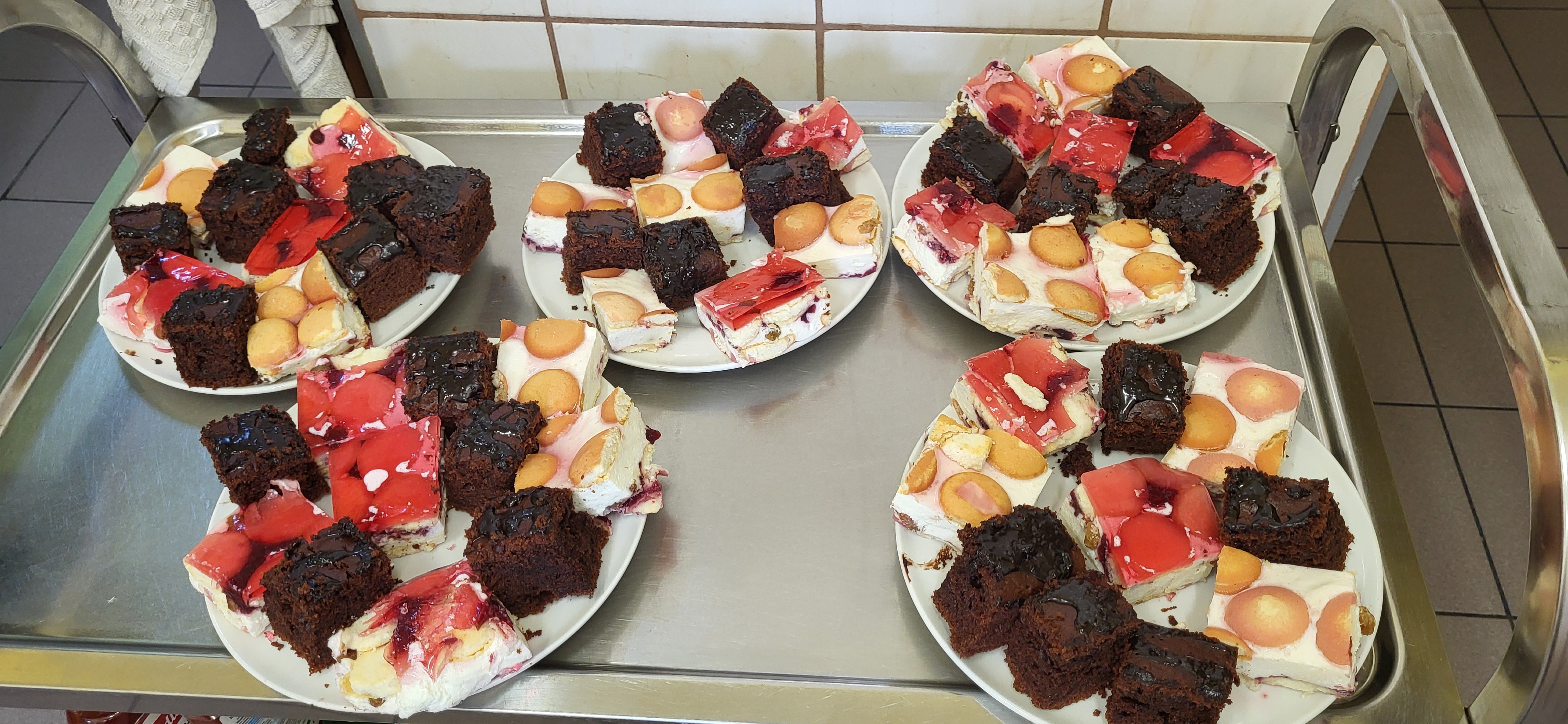 Zdjęcie przedstawia pokrojone upieczone ciasta serniki i pierniki